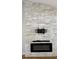 Stylish fireplace with a modern stone accent wall, offering a cozy and inviting ambiance in the living space at 6428 Lynn Rd, Orlando, FL 32810