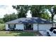 Charming single-story home featuring a well-manicured lawn, brick entrance, and attached garage at 6428 Lynn Rd, Orlando, FL 32810