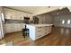 Bright kitchen features an island with bar stool seating and white cabinets with quartz countertops at 6428 Lynn Rd, Orlando, FL 32810