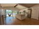 Sunlit kitchen with island, stainless steel appliances, and pantry offers modern convenience at 6428 Lynn Rd, Orlando, FL 32810