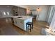 Open-concept dining area featuring a large island, a shiplap wall and access to the outside patio at 6428 Lynn Rd, Orlando, FL 32810