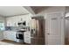 Beautifully updated kitchen featuring stainless steel appliances, white cabinetry, and quartz countertops at 6428 Lynn Rd, Orlando, FL 32810