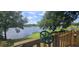 Tranquil lake view from the backyard treehouse deck with steering wheel and telescope at 6428 Lynn Rd, Orlando, FL 32810