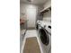 Laundry room with a folding counter, modern appliances, and plenty of storage at 6428 Lynn Rd, Orlando, FL 32810