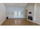 Open living room with wood floors, brick fireplace, and white french doors at 6428 Lynn Rd, Orlando, FL 32810