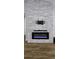 Modern living room with a stylish stone accent wall and an electric fireplace at 6428 Lynn Rd, Orlando, FL 32810