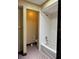 Bathroom featuring a white tiled shower and patterned flooring at 6616 Blanche Ct, Orlando, FL 32818