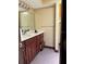 Bathroom with a dark wood vanity and patterned flooring at 6616 Blanche Ct, Orlando, FL 32818