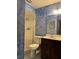 Full bathroom featuring blue textured walls and a shower with a glass door at 6616 Blanche Ct, Orlando, FL 32818