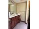 Bathroom with a dark wood vanity and patterned flooring at 6616 Blanche Ct, Orlando, FL 32818