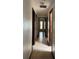 Neutral-colored hallway with tile floor and several doors leading to other rooms in the house at 6616 Blanche Ct, Orlando, FL 32818