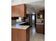 Functional kitchen space with wood cabinets, tiled floor and a stainless steel refrigerator at 6616 Blanche Ct, Orlando, FL 32818