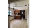 Bright kitchen featuring wood cabinetry, breakfast bar, neutral countertops, and tiled flooring at 6616 Blanche Ct, Orlando, FL 32818