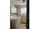 Functional laundry room featuring a washer, dryer, storage cabinets, and a window for natural light at 6616 Blanche Ct, Orlando, FL 32818