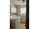 Functional laundry room featuring a washer, dryer, storage cabinets, and a window for natural light at 6616 Blanche Ct, Orlando, FL 32818