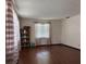 Bright living room with hardwood floors, window, and a classic built-in display cabinet at 6616 Blanche Ct, Orlando, FL 32818