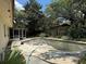 Backyard view of inground pool needing repair, with screened in patio and grassy area at 6616 Blanche Ct, Orlando, FL 32818