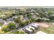 An aerial view of the neighborhood featuring mature trees and local amenities such as tennis courts at 765 Coach Light Dr, Casselberry, FL 32730