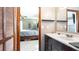 Bathroom featuring a sink vanity with wood cabinets and a view into the primary bedroom at 765 Coach Light Dr, Casselberry, FL 32730