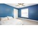 Cozy bedroom with a carpet floor, features a ceiling fan, bright window, and closet, offering comfort and functionality at 765 Coach Light Dr, Casselberry, FL 32730