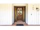 Elegant front door with glass panel and charming accents at 765 Coach Light Dr, Casselberry, FL 32730