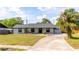 Charming single-story home featuring lush landscaping and a welcoming front porch at 765 Coach Light Dr, Casselberry, FL 32730
