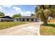 Inviting single-story home with lush landscaping and a charming, covered front porch at 765 Coach Light Dr, Casselberry, FL 32730