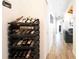 Hallway featuring hardwood floors and a wine rack, adding a touch of elegance and sophistication to the home's interior design at 765 Coach Light Dr, Casselberry, FL 32730
