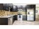 A kitchen with stainless steel appliances, black cabinets, and granite countertops at 765 Coach Light Dr, Casselberry, FL 32730