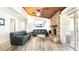 A living room featuring a brick fireplace, wood ceiling, and sliding glass doors at 765 Coach Light Dr, Casselberry, FL 32730