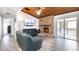 Comfortable living room with a brick fireplace, wood ceiling, and sliding glass doors at 765 Coach Light Dr, Casselberry, FL 32730