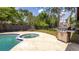 Backyard pool and patio area featuring a built-in spa and stainless steel gas grill for outdoor entertaining at 765 Coach Light Dr, Casselberry, FL 32730