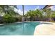 Backyard featuring a kidney shaped pool, spa and wooden fencing at 765 Coach Light Dr, Casselberry, FL 32730