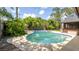 Backyard featuring a kidney shaped pool with a paved patio and mature trees at 765 Coach Light Dr, Casselberry, FL 32730