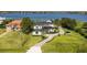 Aerial view of a waterfront property with manicured grounds, brick driveway and a lake view at 7706 Ficquette Rd, Windermere, FL 34786