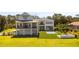 Spacious backyard featuring an in-ground pool, manicured lawn, a covered patio and an outdoor firepit at 7706 Ficquette Rd, Windermere, FL 34786