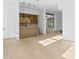 An indoor bar features a wooden facade, open shelving, mini fridge, and pendant lighting for a modern design at 7706 Ficquette Rd, Windermere, FL 34786
