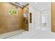 Modern bathroom with a glass-enclosed shower and wood paneling, offering a spa-like ambiance at 7706 Ficquette Rd, Windermere, FL 34786