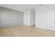 Well-lit bedroom with light gray walls, modern trim work, light hardwood flooring, and recessed lighting at 7706 Ficquette Rd, Windermere, FL 34786