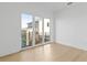 Bedroom featuring large windows with view and wood flooring at 7706 Ficquette Rd, Windermere, FL 34786