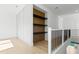 Hallway with railing that features storage cabinets with black shelves at 7706 Ficquette Rd, Windermere, FL 34786