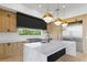 Bright kitchen boasts white marble countertops, custom cabinets, and stainless steel appliances at 7706 Ficquette Rd, Windermere, FL 34786