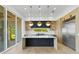 Modern open-concept kitchen featuring wood floors, a large island, and stainless steel appliances at 7706 Ficquette Rd, Windermere, FL 34786