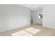 Bright room with wooden floors, white walls, and storage cabinets at 7706 Ficquette Rd, Windermere, FL 34786