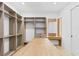 Bright walk-in closet with wood shelving, a center island and a vanity with a mirror at 7706 Ficquette Rd, Windermere, FL 34786