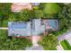 Overhead view of home with solar panels, screened pool, and established trees at 8335 Lake Burden Circle, Windermere, FL 34786