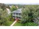 Aerial view of home showcasing landscaped yard and surrounding trees at 8335 Lake Burden Circle, Windermere, FL 34786