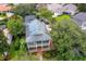 Aerial view of home with solar panels, pool, and lush surroundings at 8335 Lake Burden Circle, Windermere, FL 34786