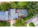 Aerial view of home featuring a screened pool and lush landscaping at 8335 Lake Burden Circle, Windermere, FL 34786