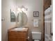 Cozy bathroom featuring a vanity with a sink, toilet, and a shower with a stylish curtain at 8335 Lake Burden Circle, Windermere, FL 34786